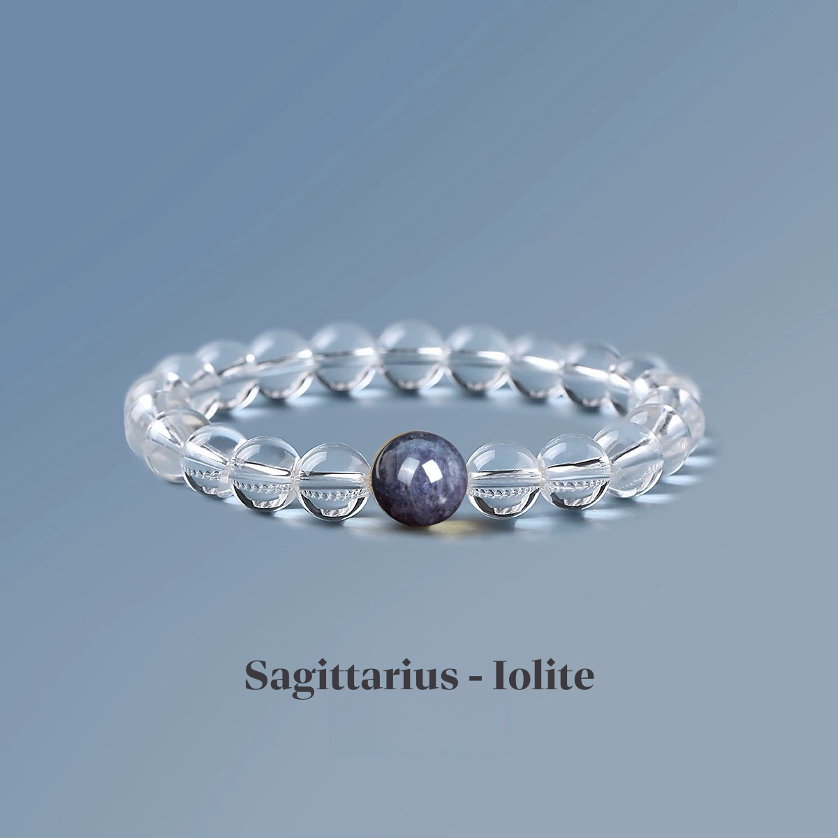 Clear quartz zodiac bracelet from the Healing Jewellery collection, featuring a central iolite bead. Designed for Sagittarius, this bracelet combines the clarity of quartz with the guiding, balancing energy of iolite.