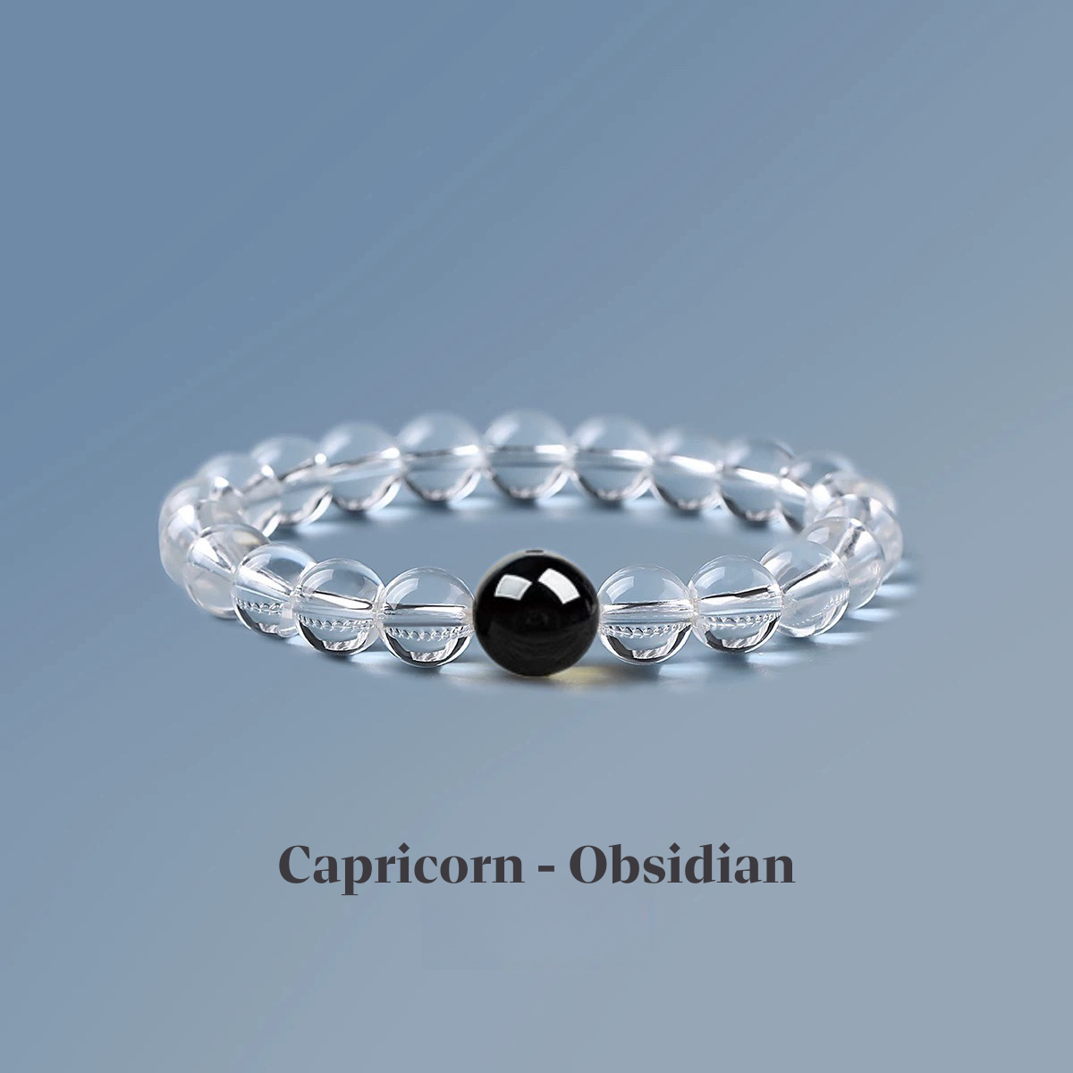 Clear quartz zodiac bracelet from the Healing Jewellery collection, featuring a central obsidian bead. Designed for Capricorn, this bracelet combines the clarity of quartz with the protective, grounding energy of obsidian.