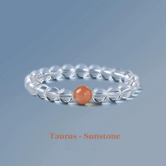 Clear quartz zodiac bracelet from the Healing Jewellery collection, featuring a central sunstone bead. Designed for Taurus, this bracelet combines the clarity of quartz with the energising, joyful qualities of sunstone.