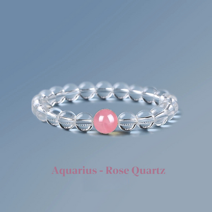 Clear quartz zodiac bracelet from the Healing Jewellery collection, featuring a central rose quartz bead. Designed for Aquarius, this bracelet combines the clarity of quartz with the gentle, loving energy of rose quartz.